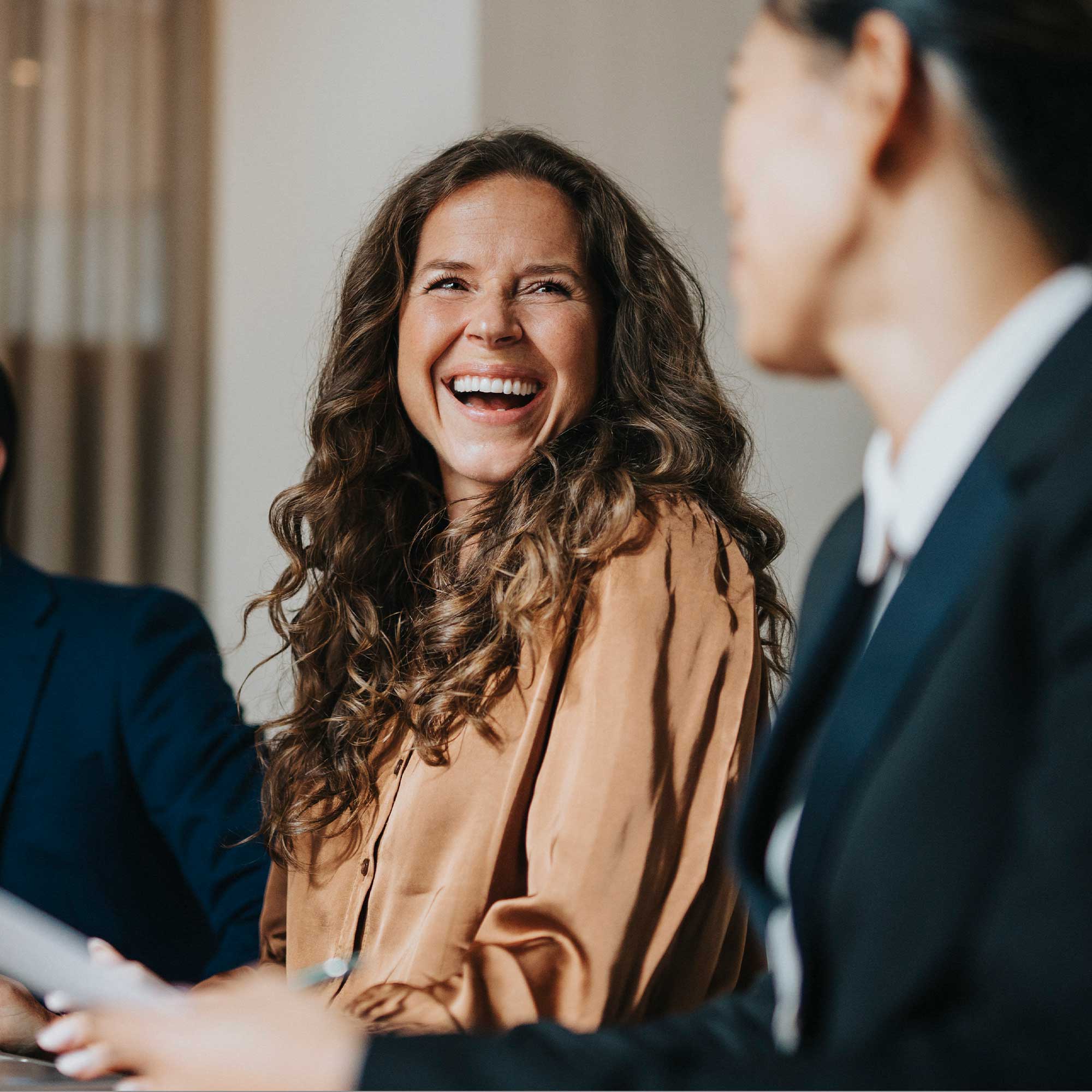 Man and woman sitting at desk smiling