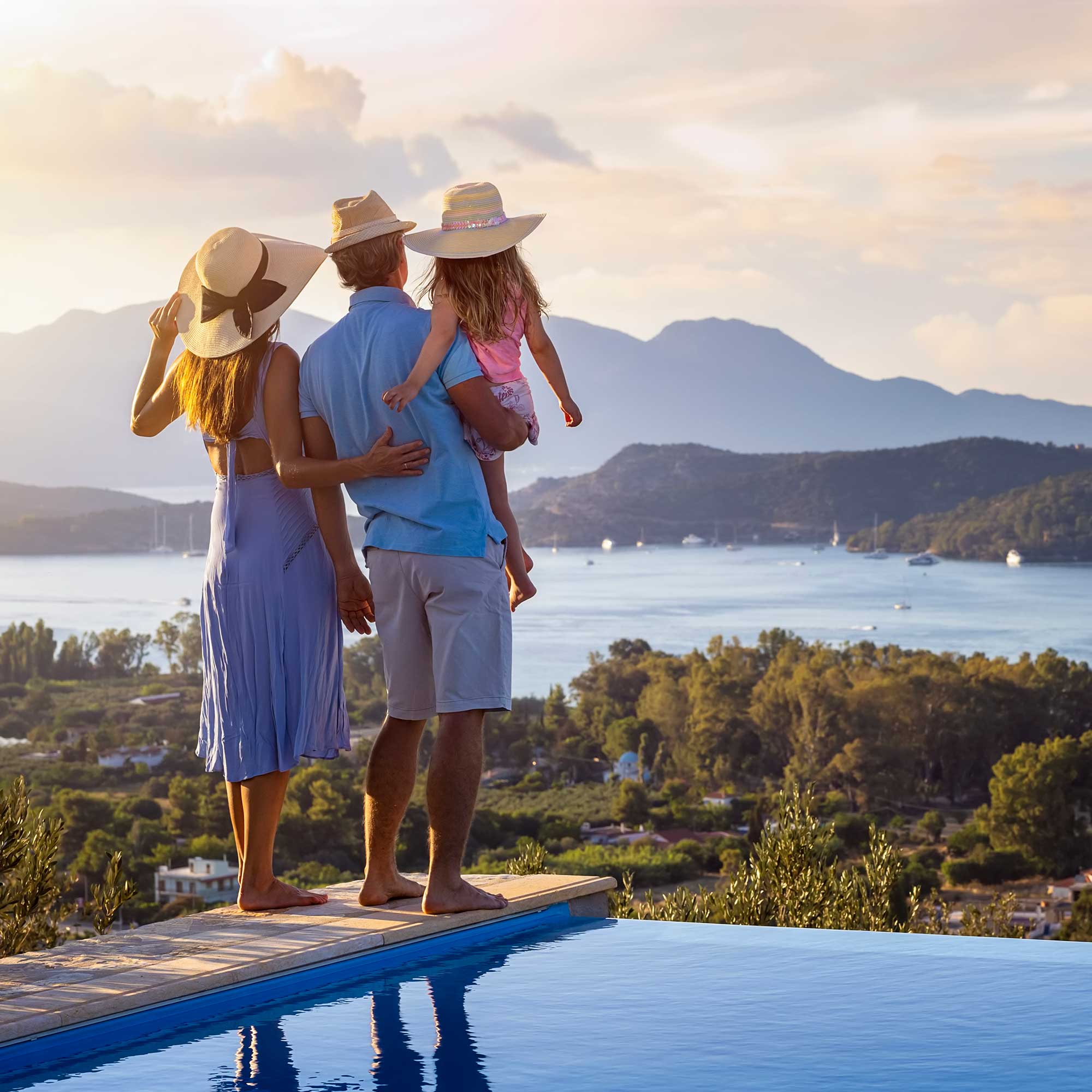 A lady rides the luggage cart as her husband pushes it.
