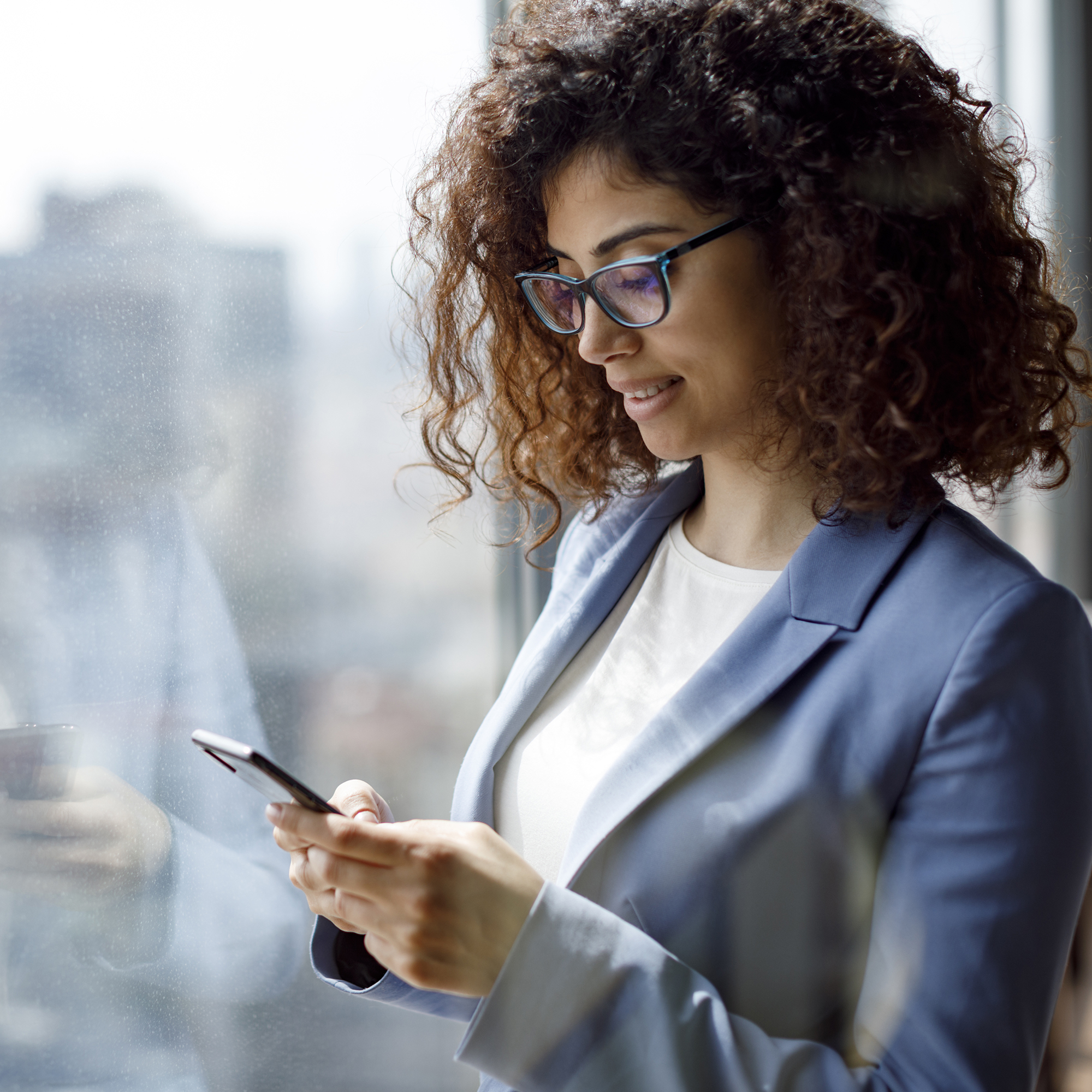 woman at the office looking at her phone.