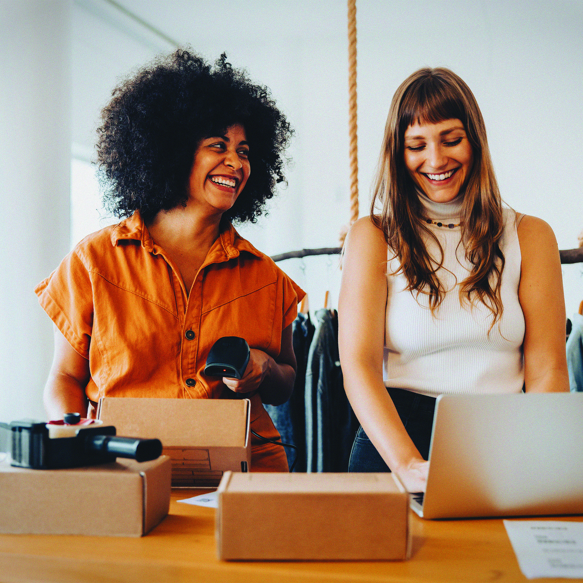 two women laughing in workplace