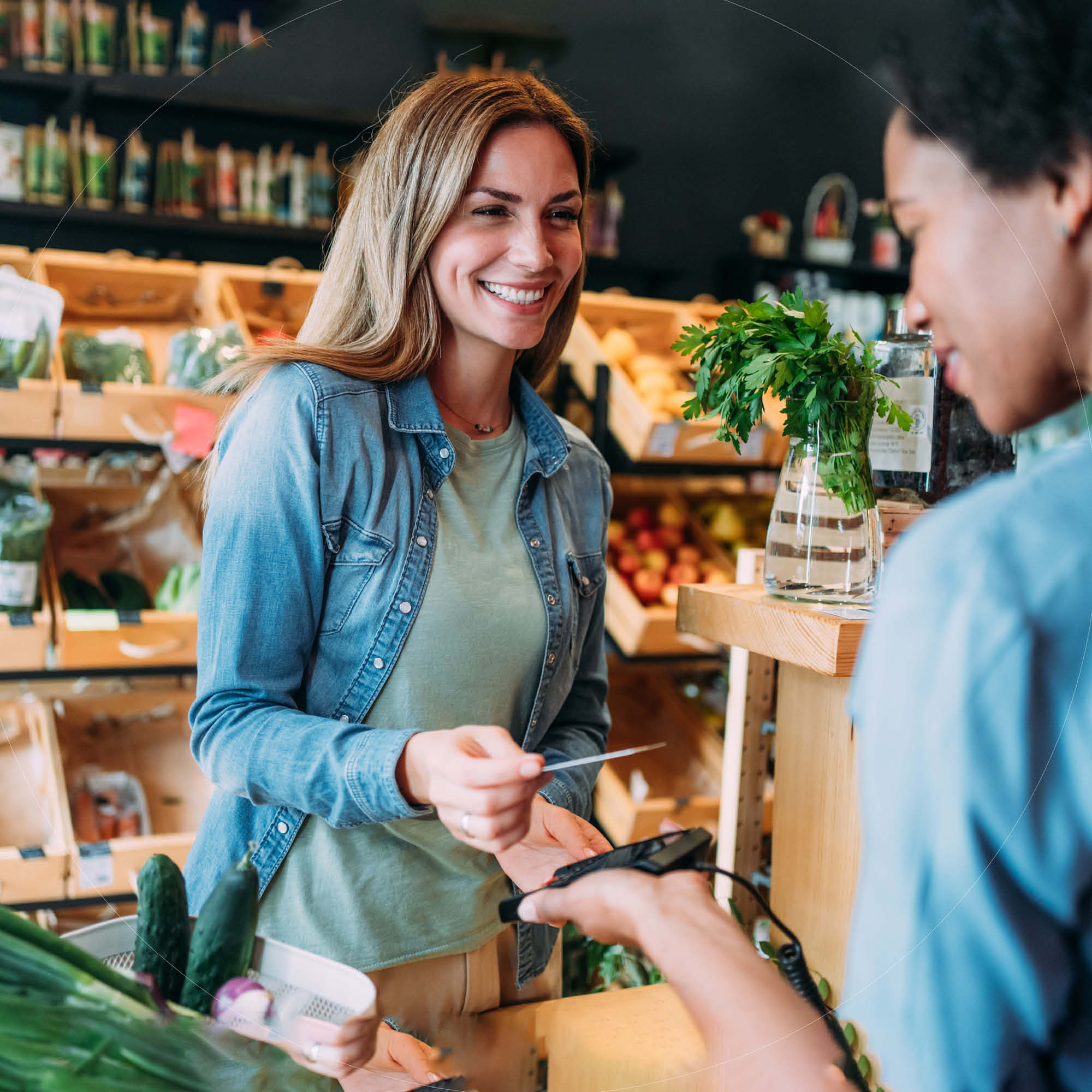 A woman using her MidFirst Bank Credit Card in a store