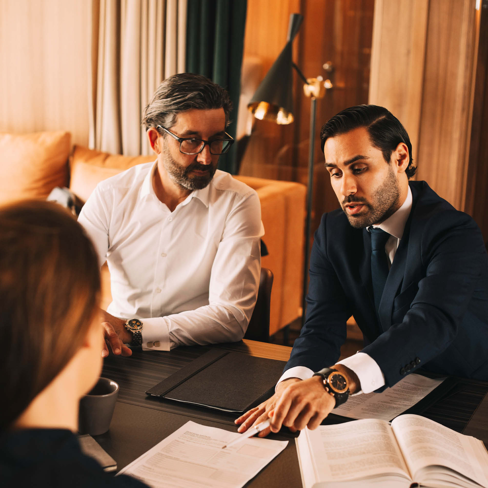 Man in office with calculator and pen in his hand smiling