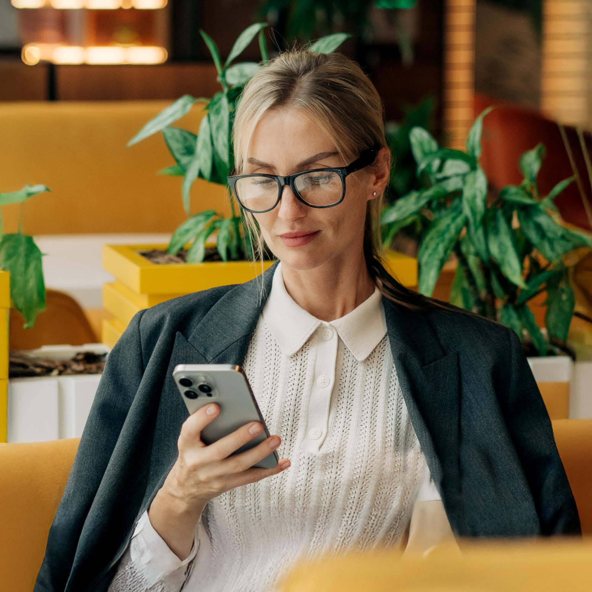 Women sitting in restaurant looking at her phone