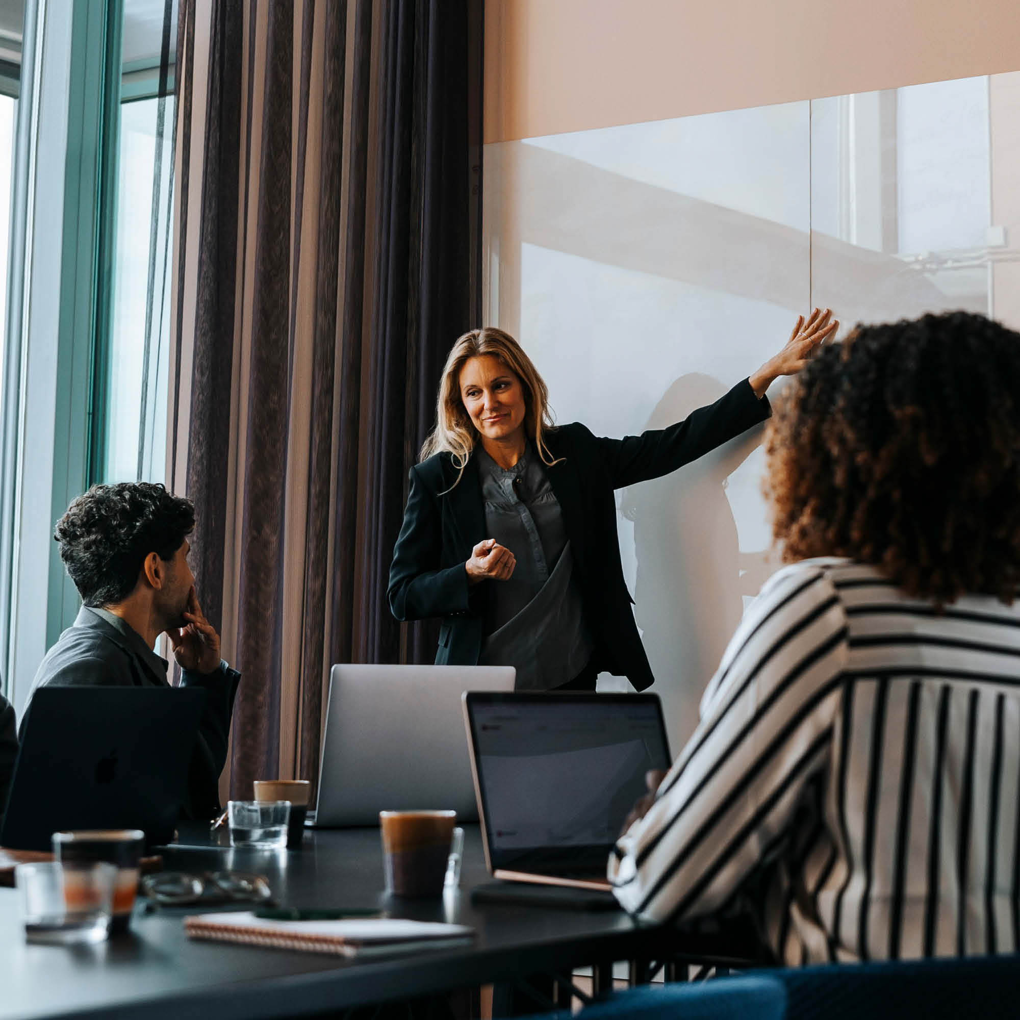 Man and two women walking and talking