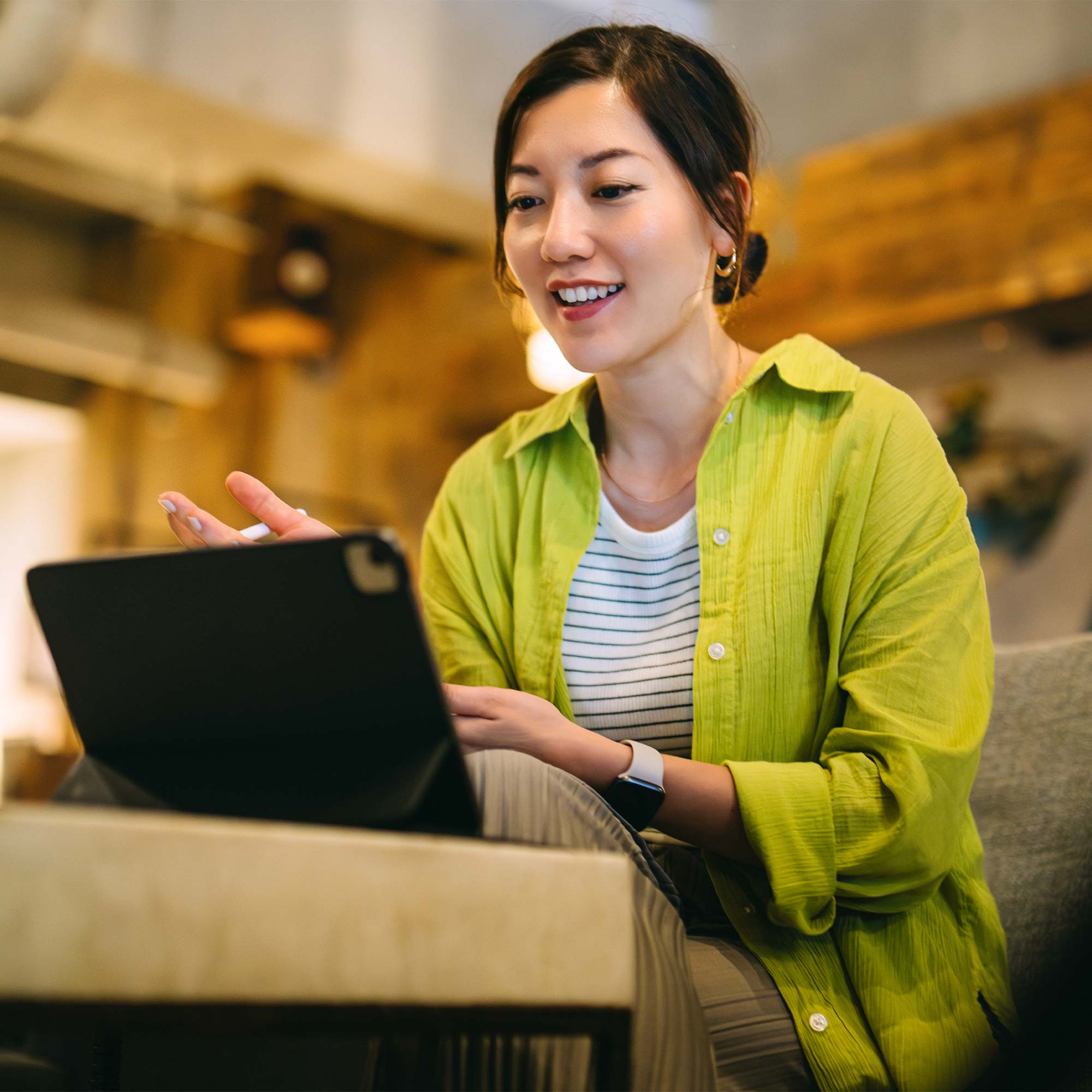 Woman sitting at a desk with a cup of coffee using her computer to look at code