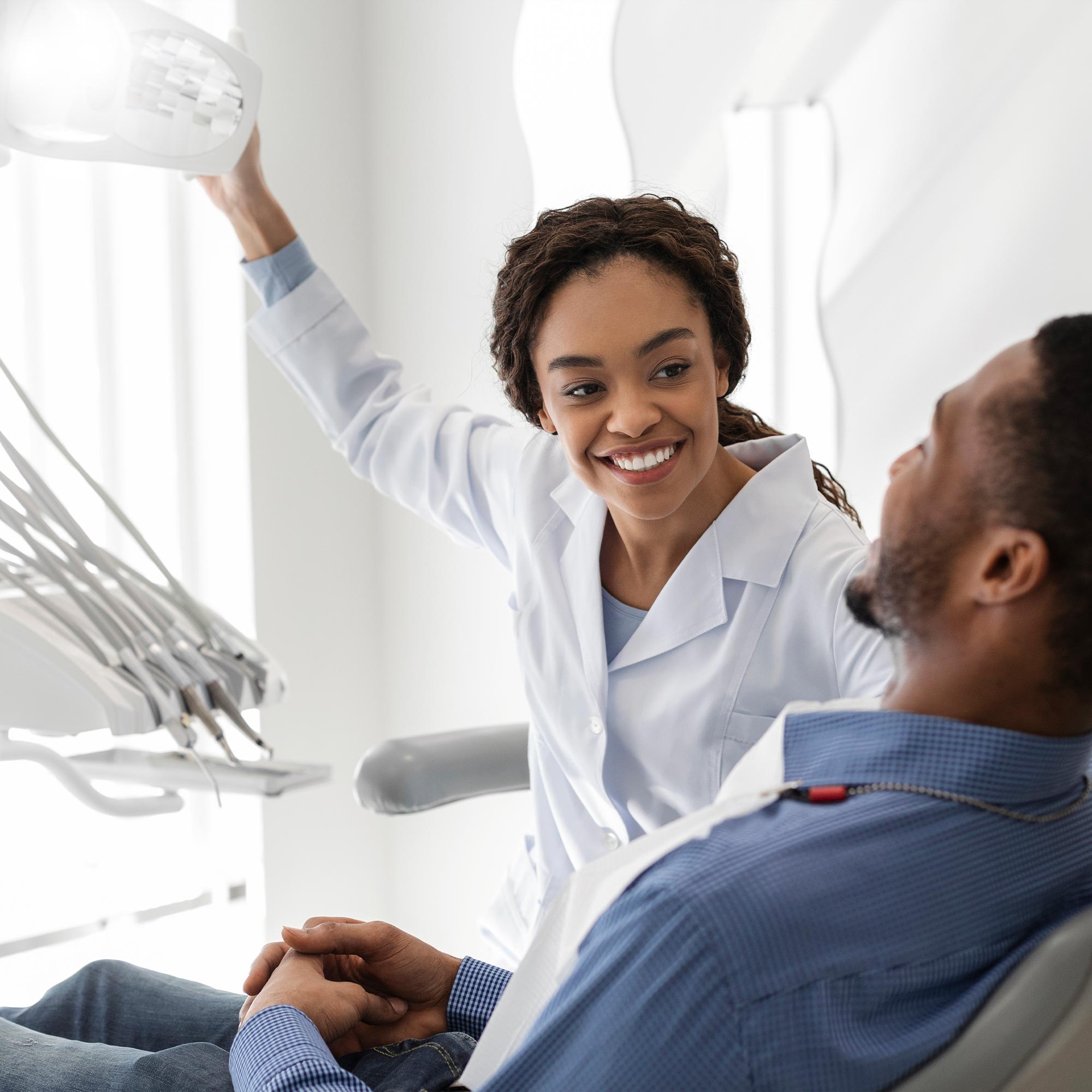 Man sitting in a patient's chair at the dentist office