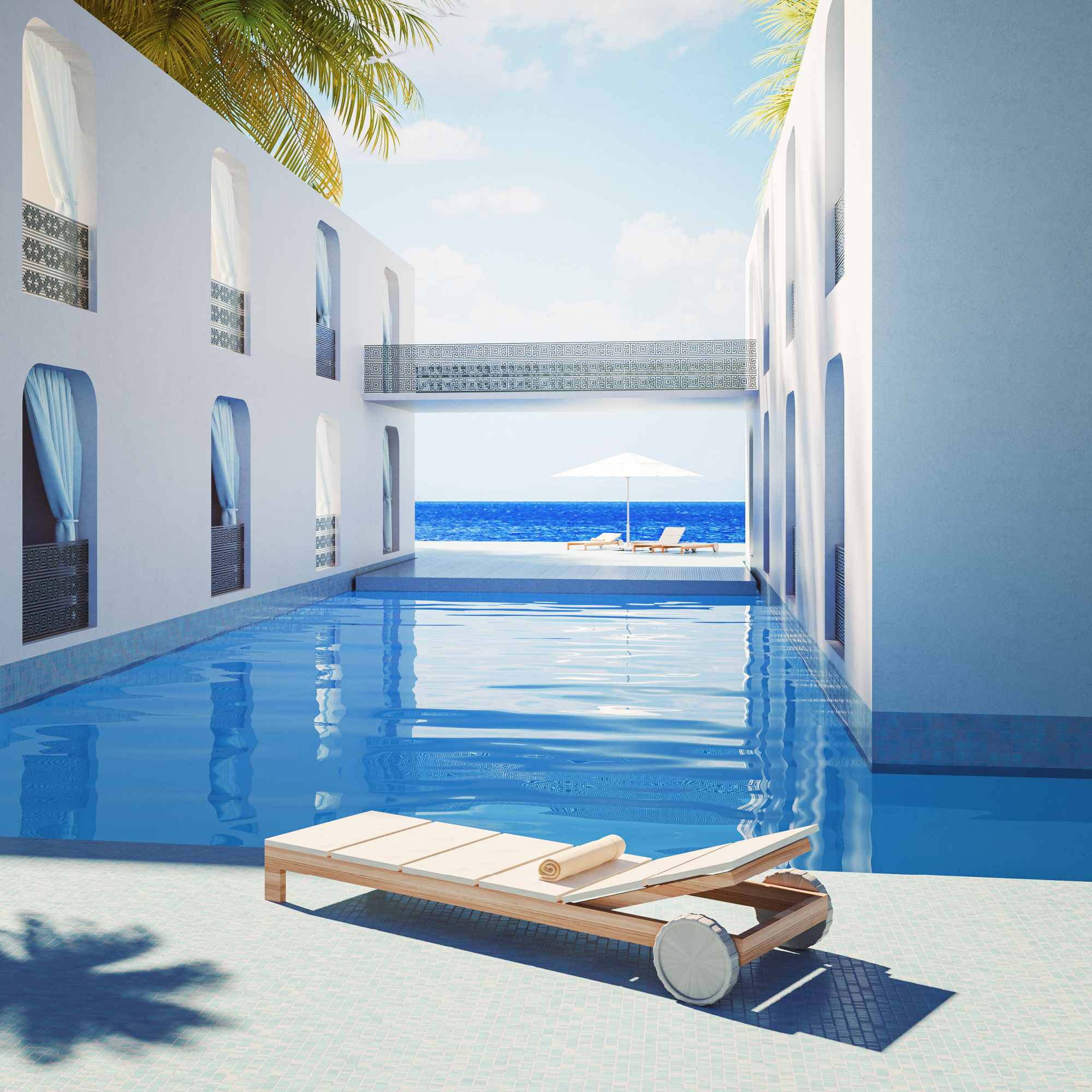 Lounge chair sits next to the pool and mansion off the beach.