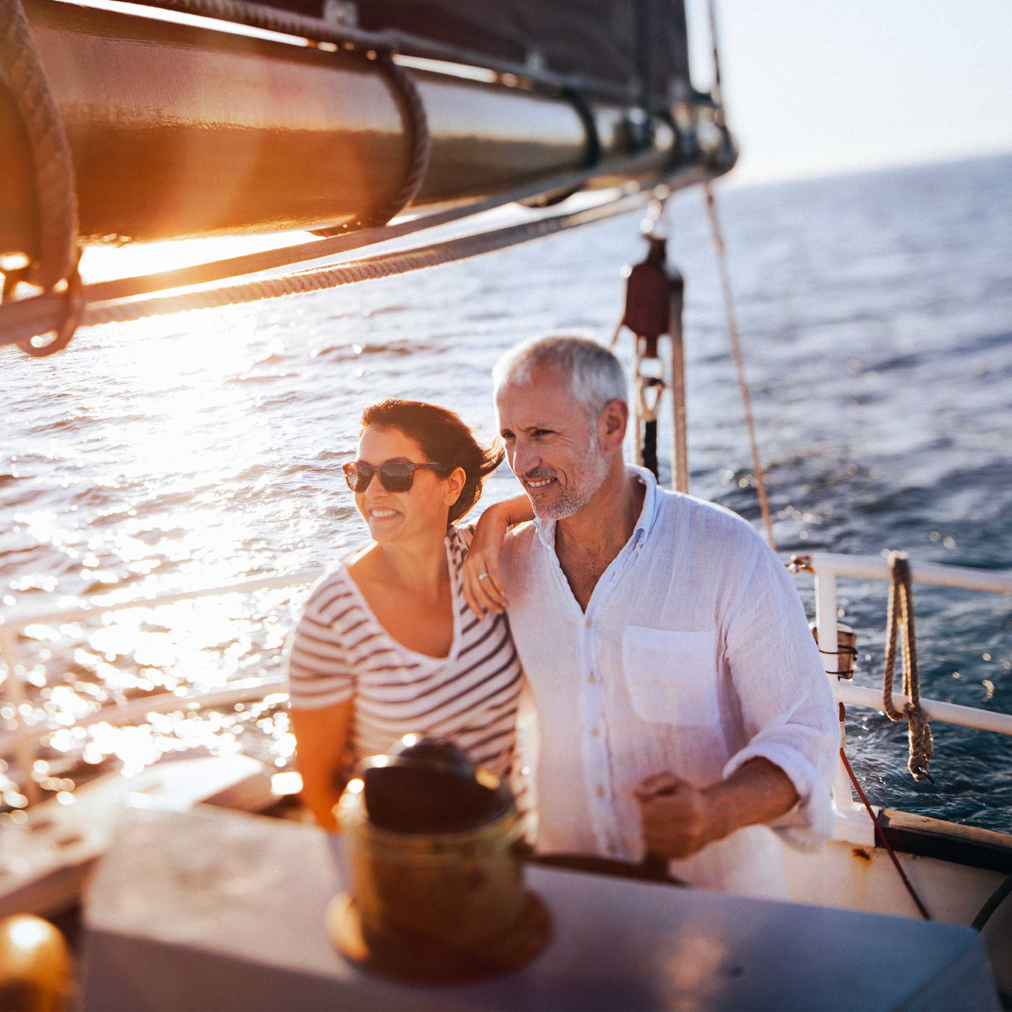A man and woman in aprons are cooking in the kitchen.