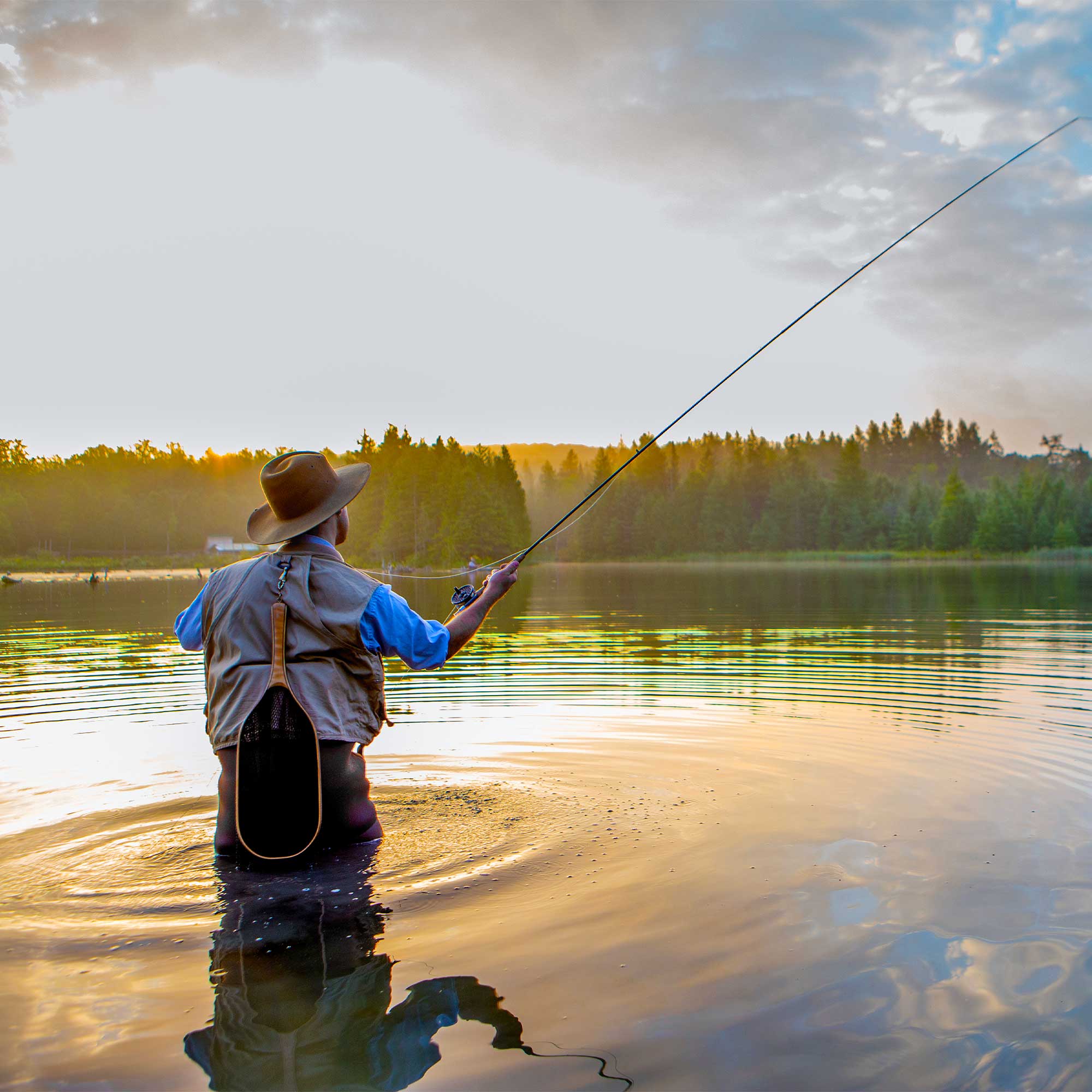 A woman smiles and watches as her daughter cracks open an egg for breakfast.