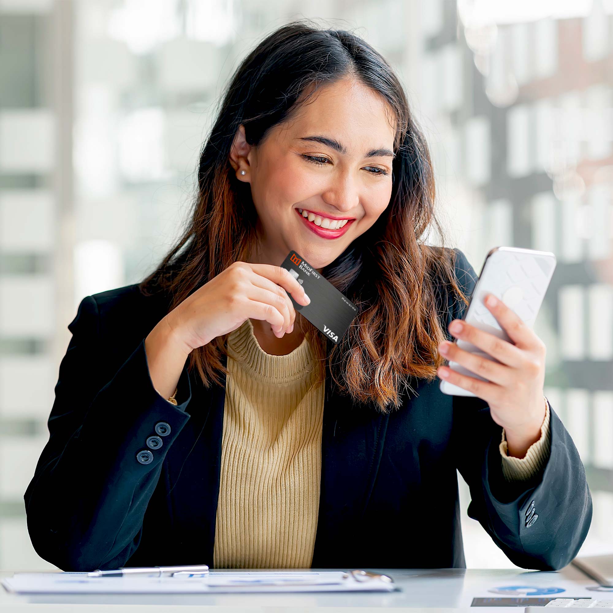 Man sitting at a bar and using a credit card to make the transaction.
