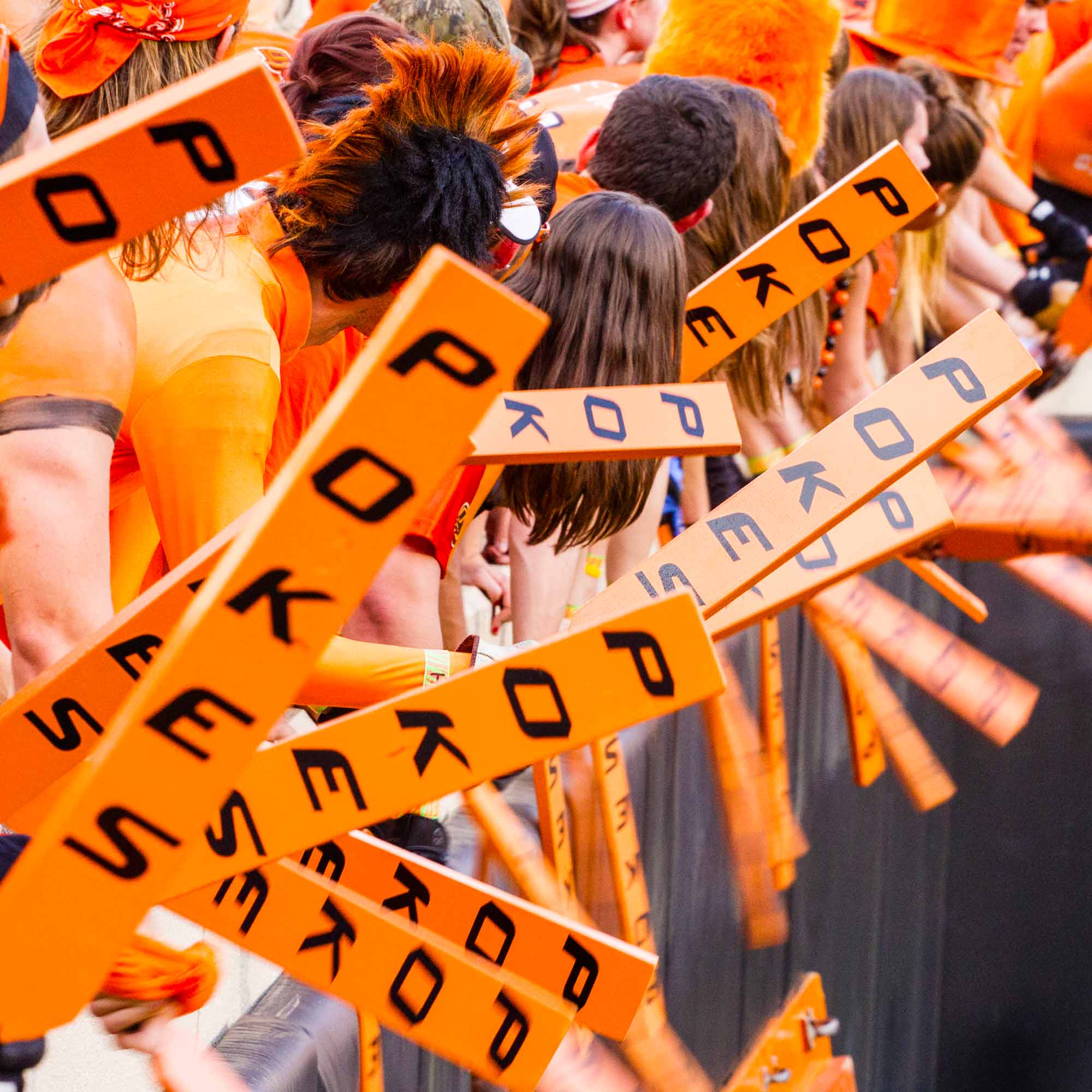 OSU students holding foam sticks at OSU football game
