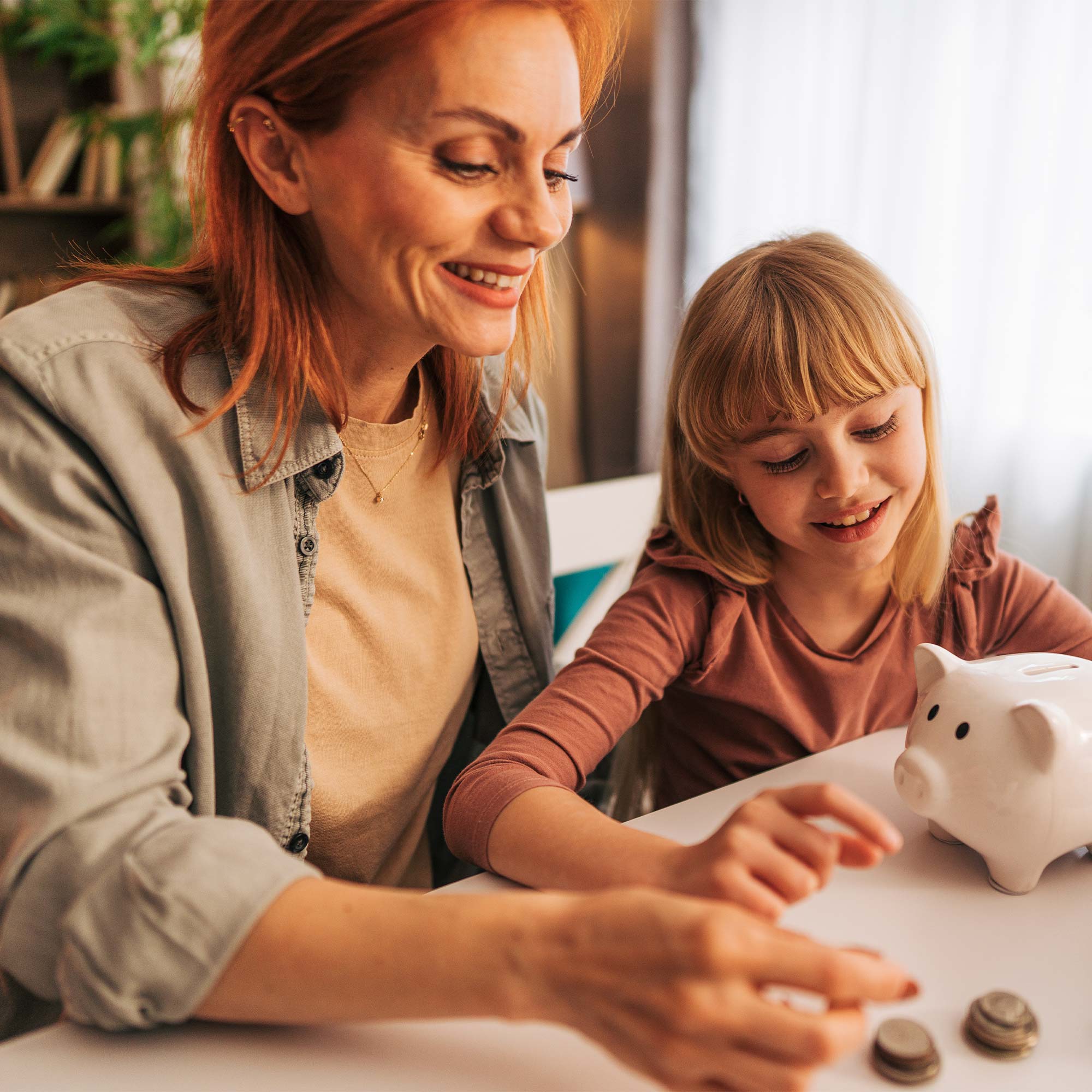 Grandma wearing a yellow shirt helps her grandson count his spare change.