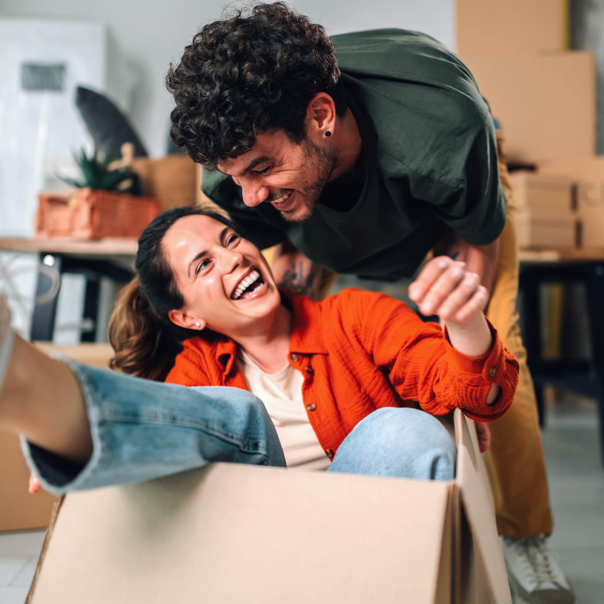 A man and woman unpack boxes in their new home.