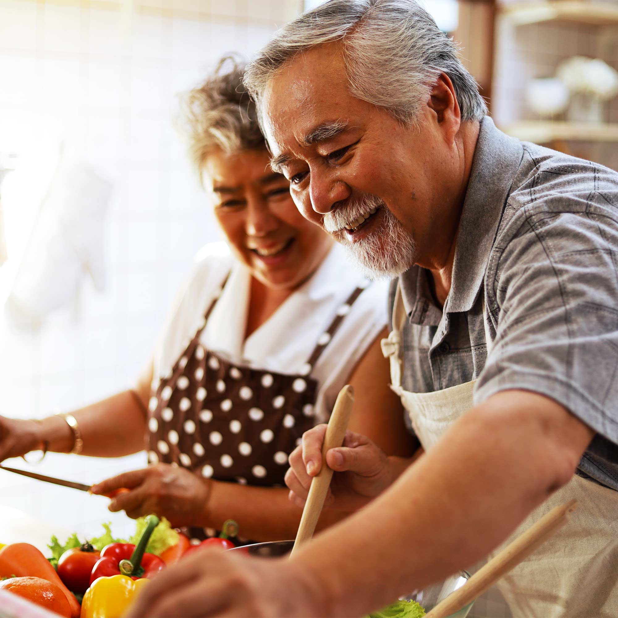 A man and woman look at produce at the food market.