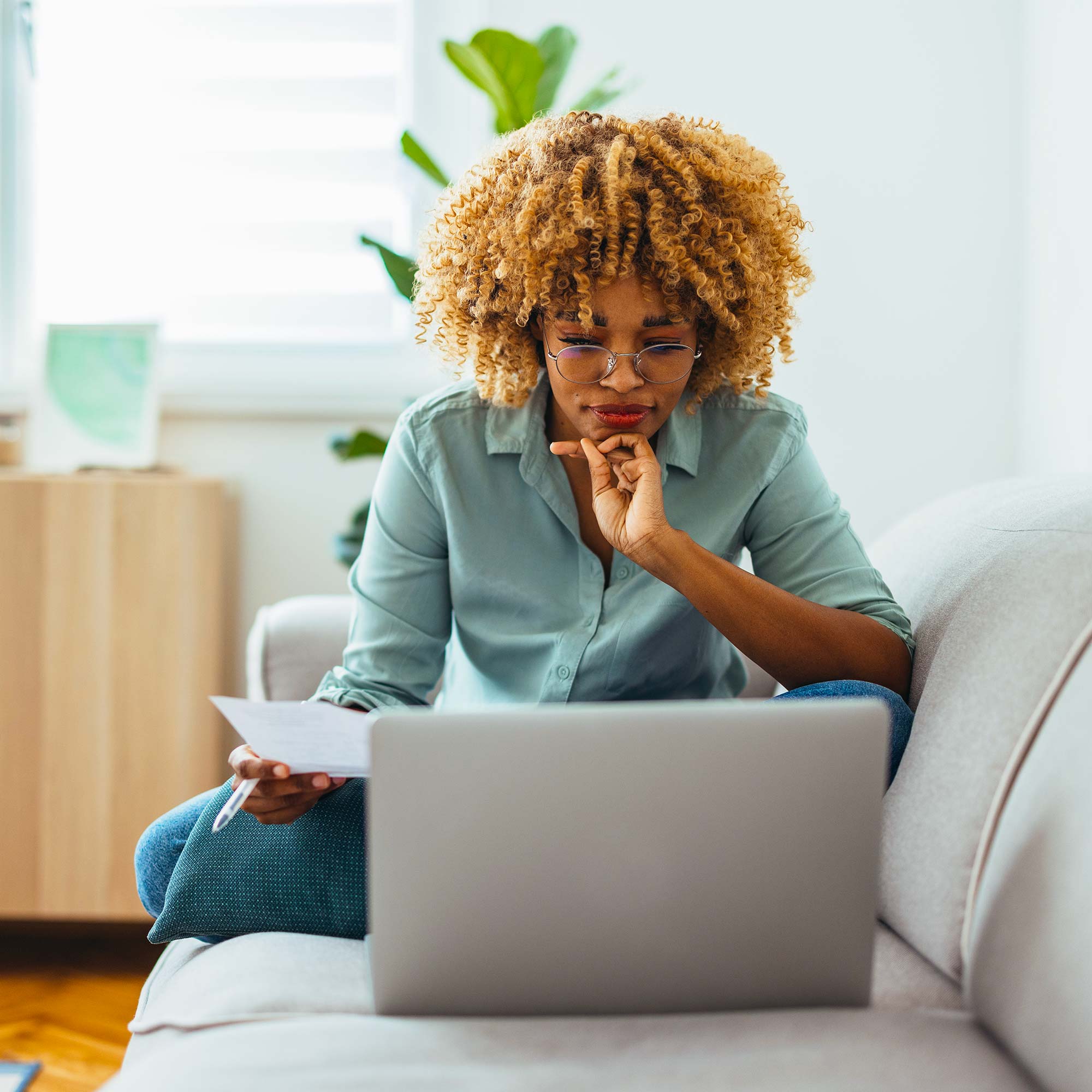 A woman looking intently at a laptop