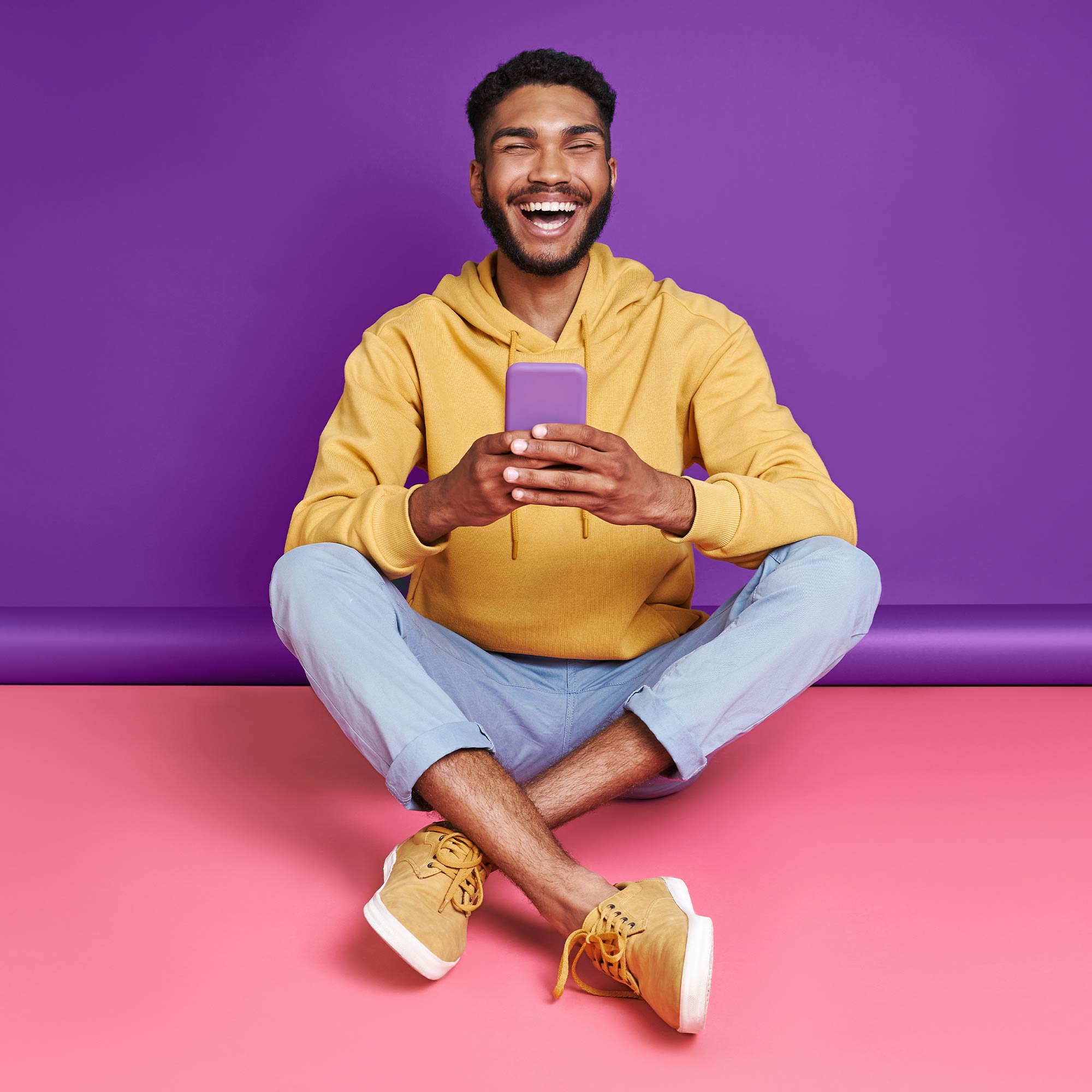 A girl wearing a purple shirt dances in front of an orange background.