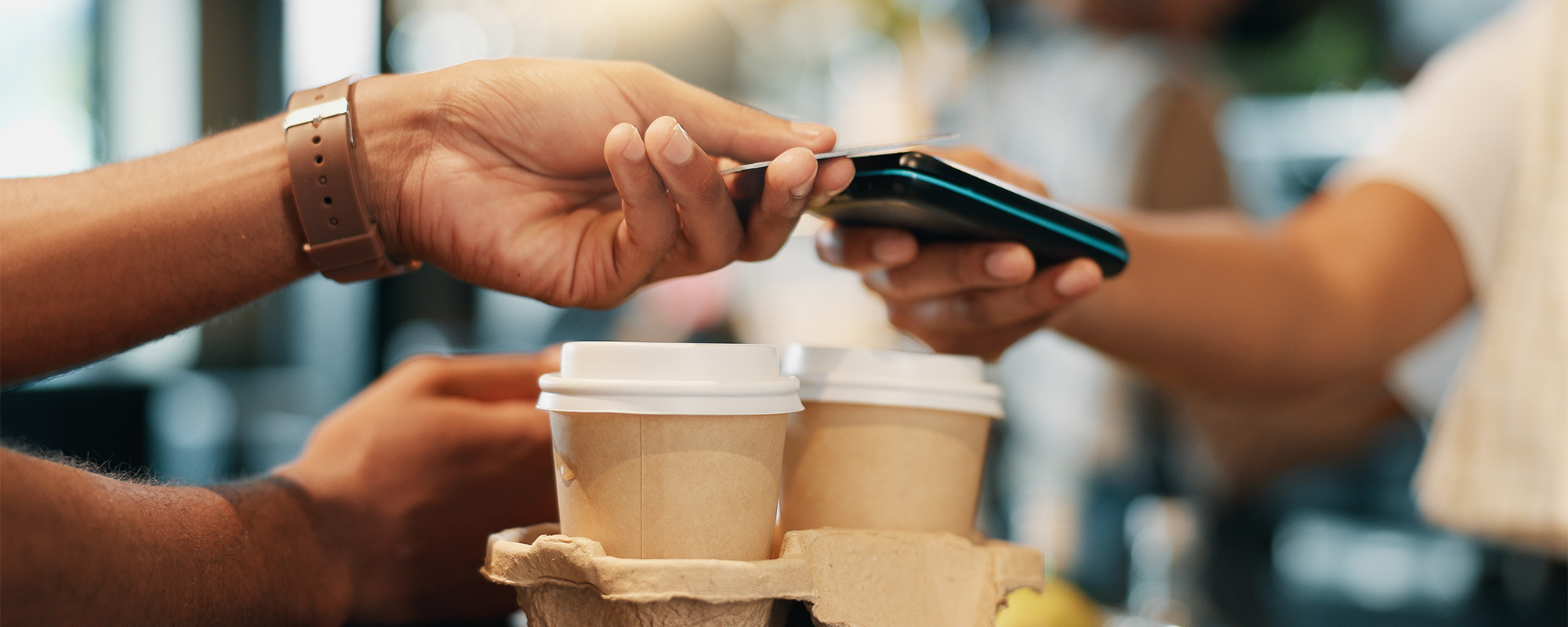A man and woman laughing while kayaking.