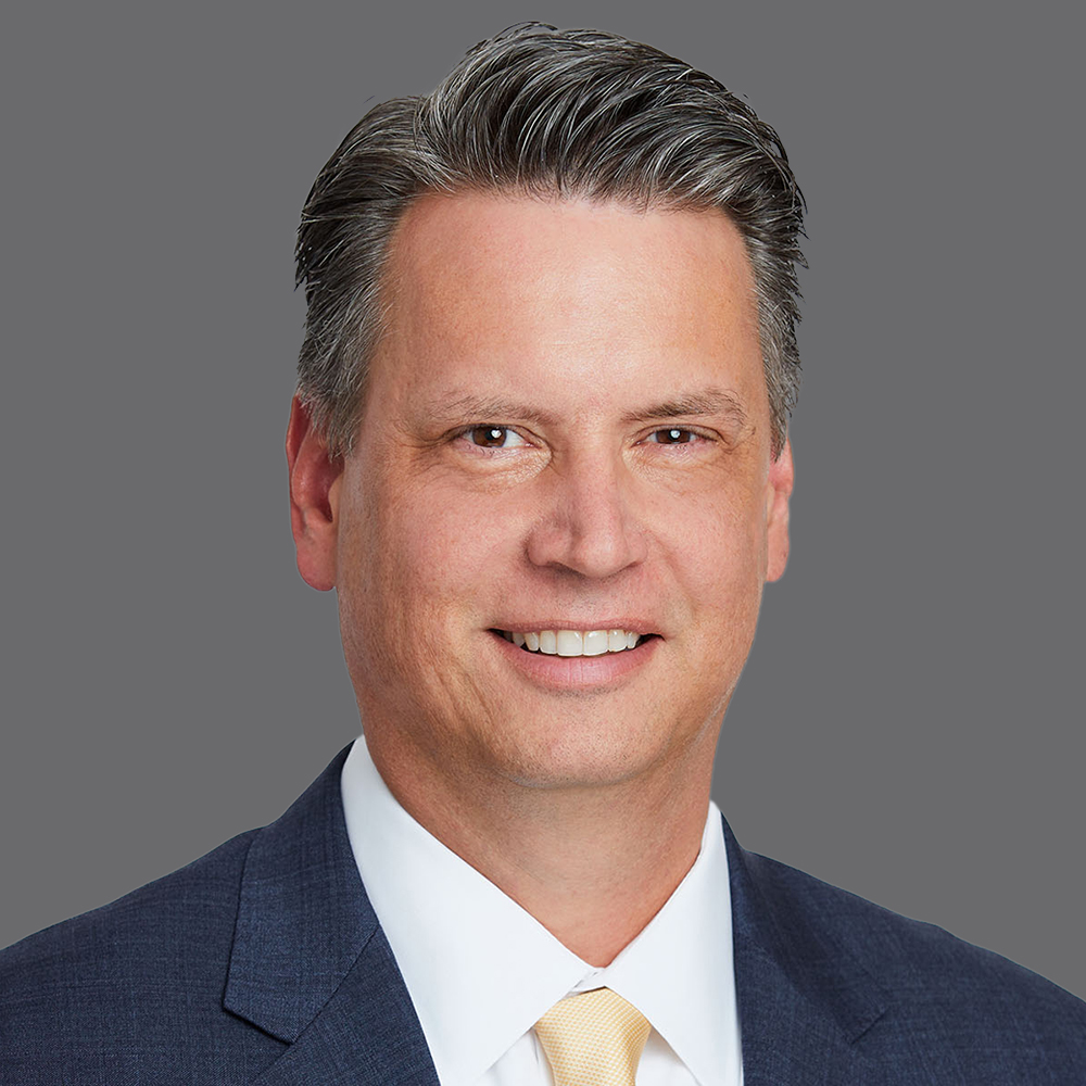 a man in a suit smiling