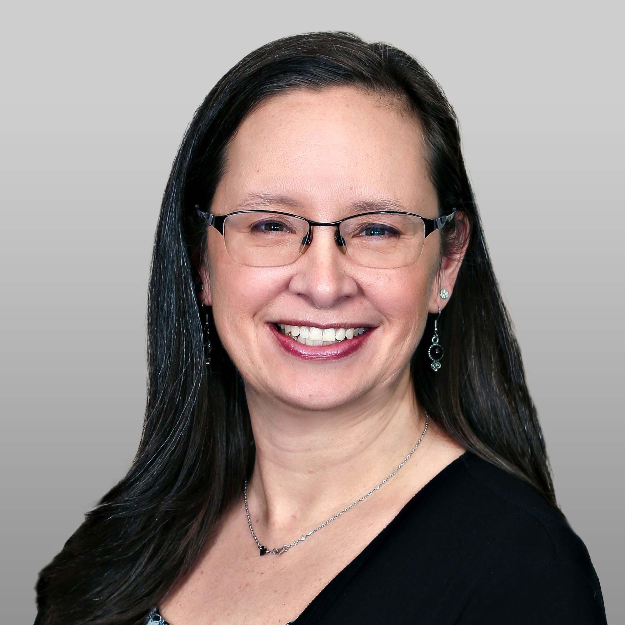 a woman wearing glasses and a necklace