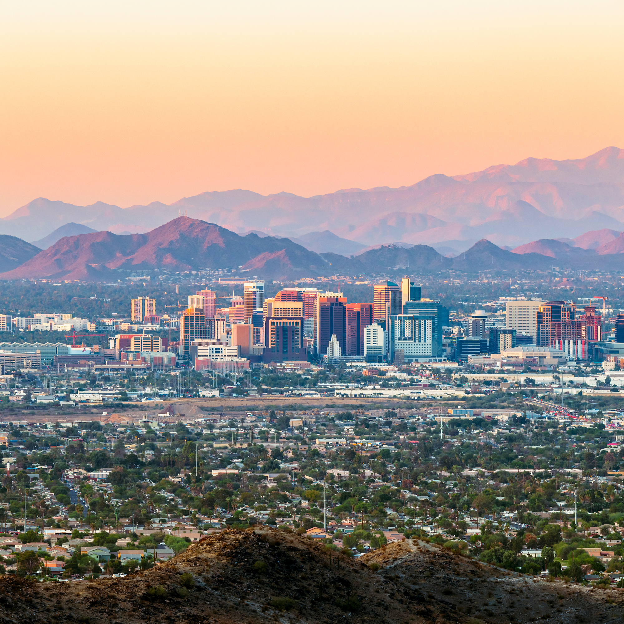 a cityscape with mountains in the background