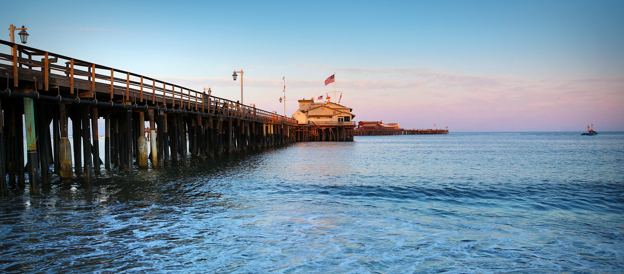 a pier with a building and a flag on it