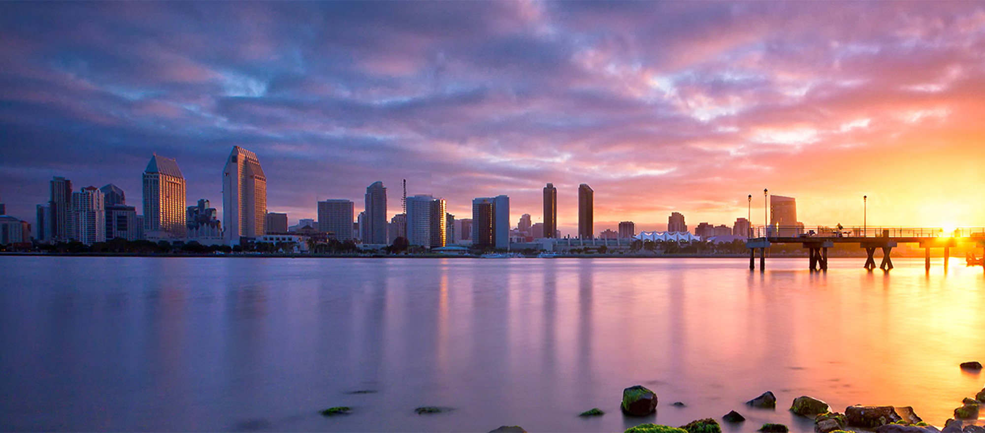 a city skyline with a body of water