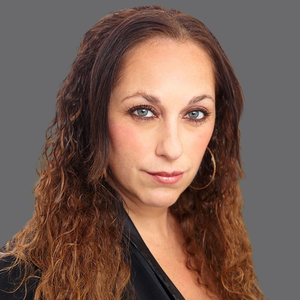 a woman with long brown hair and blue eyes