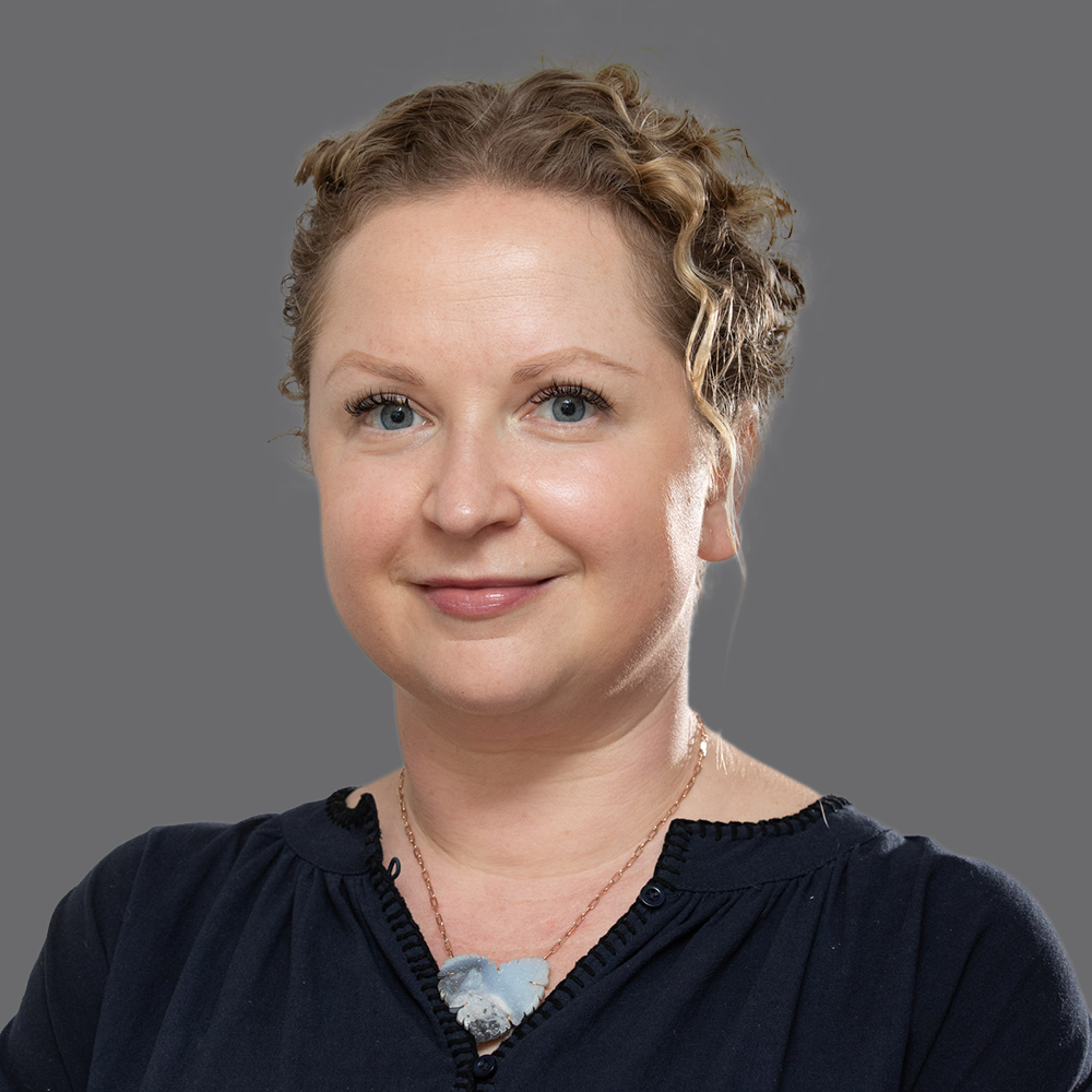 a woman with curly hair wearing a black shirt