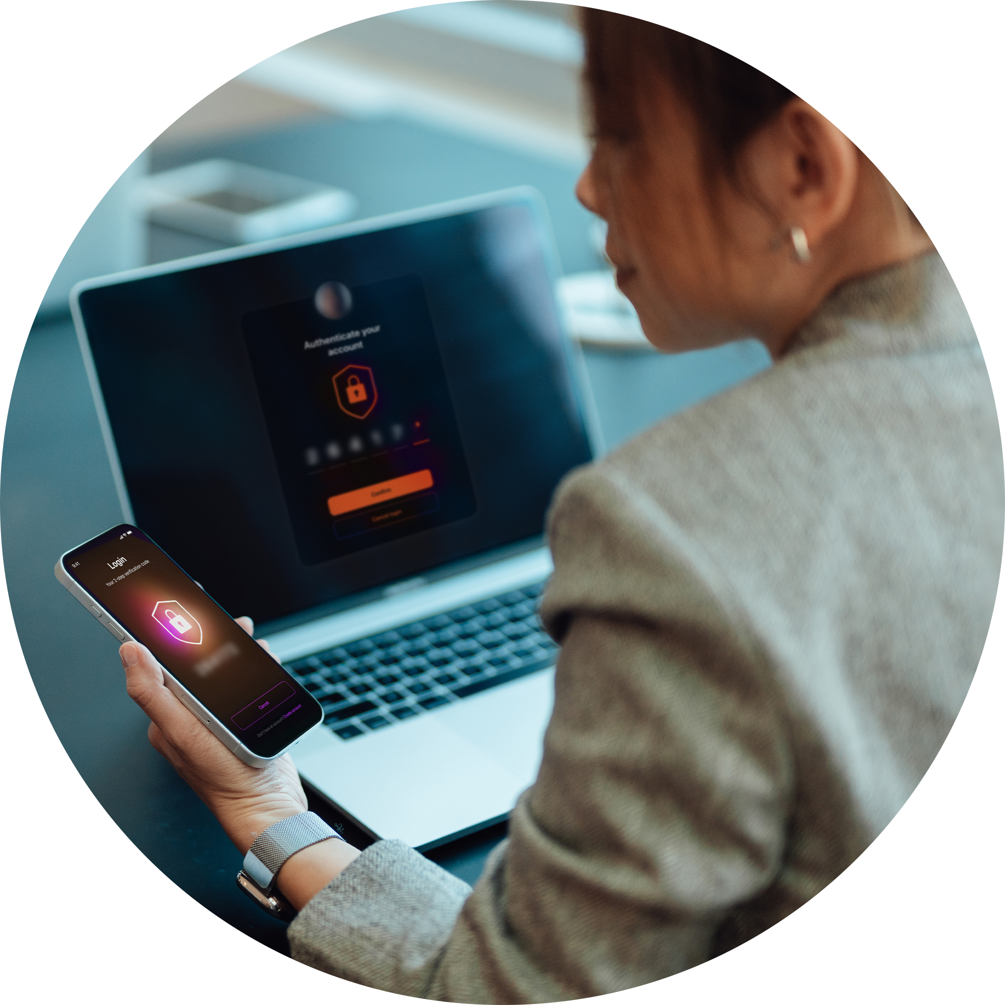 Woman looks at both her phone and computer.