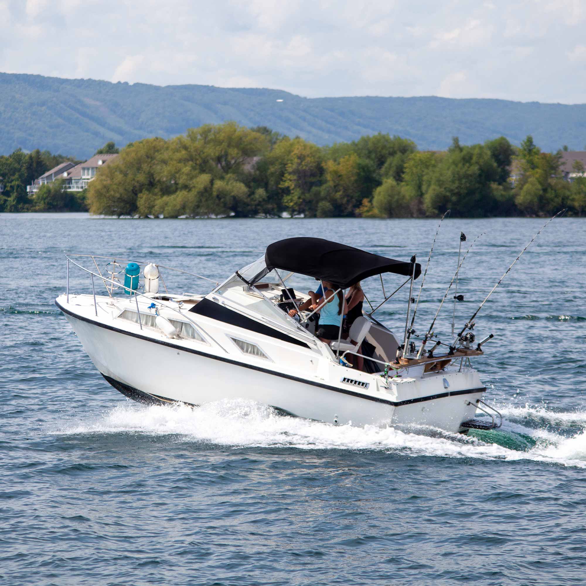 People riding in a boat in motion.