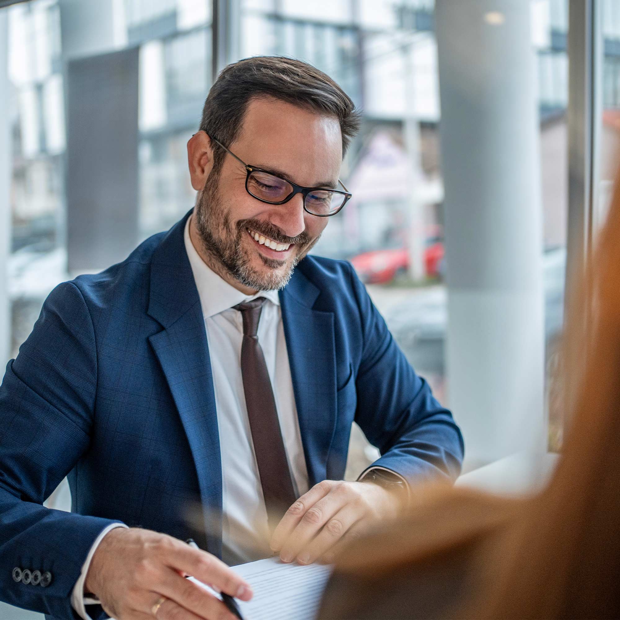 a man in a suit and tie smiling