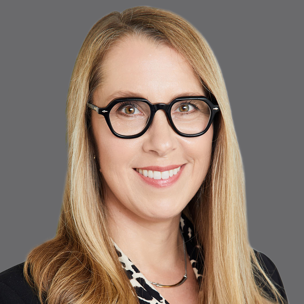 a woman with blonde hair wearing glasses