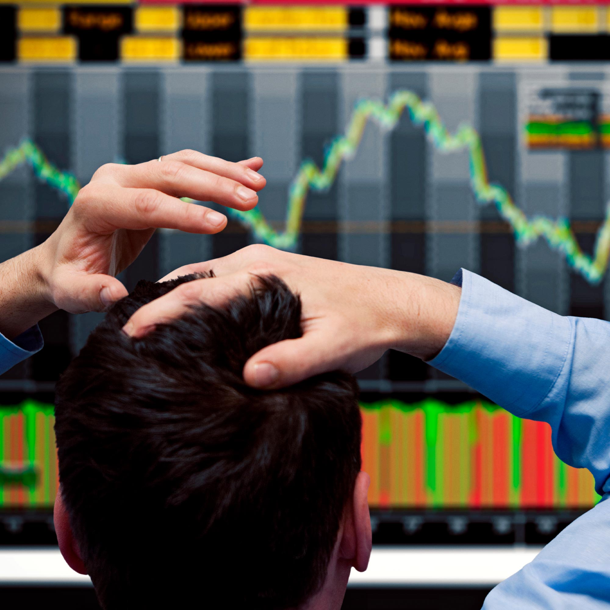 Man with hands on top of his head.