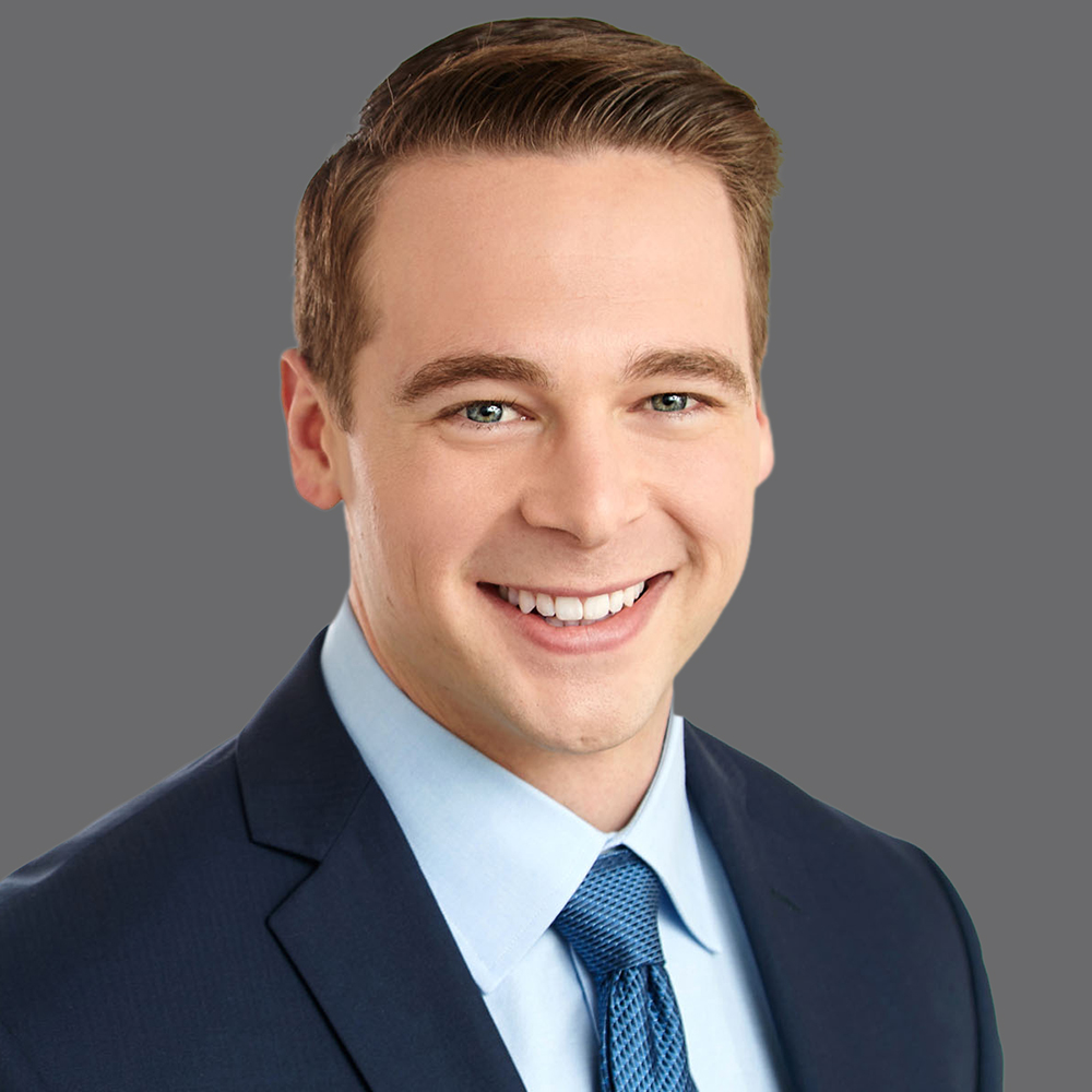a man in a suit smiling