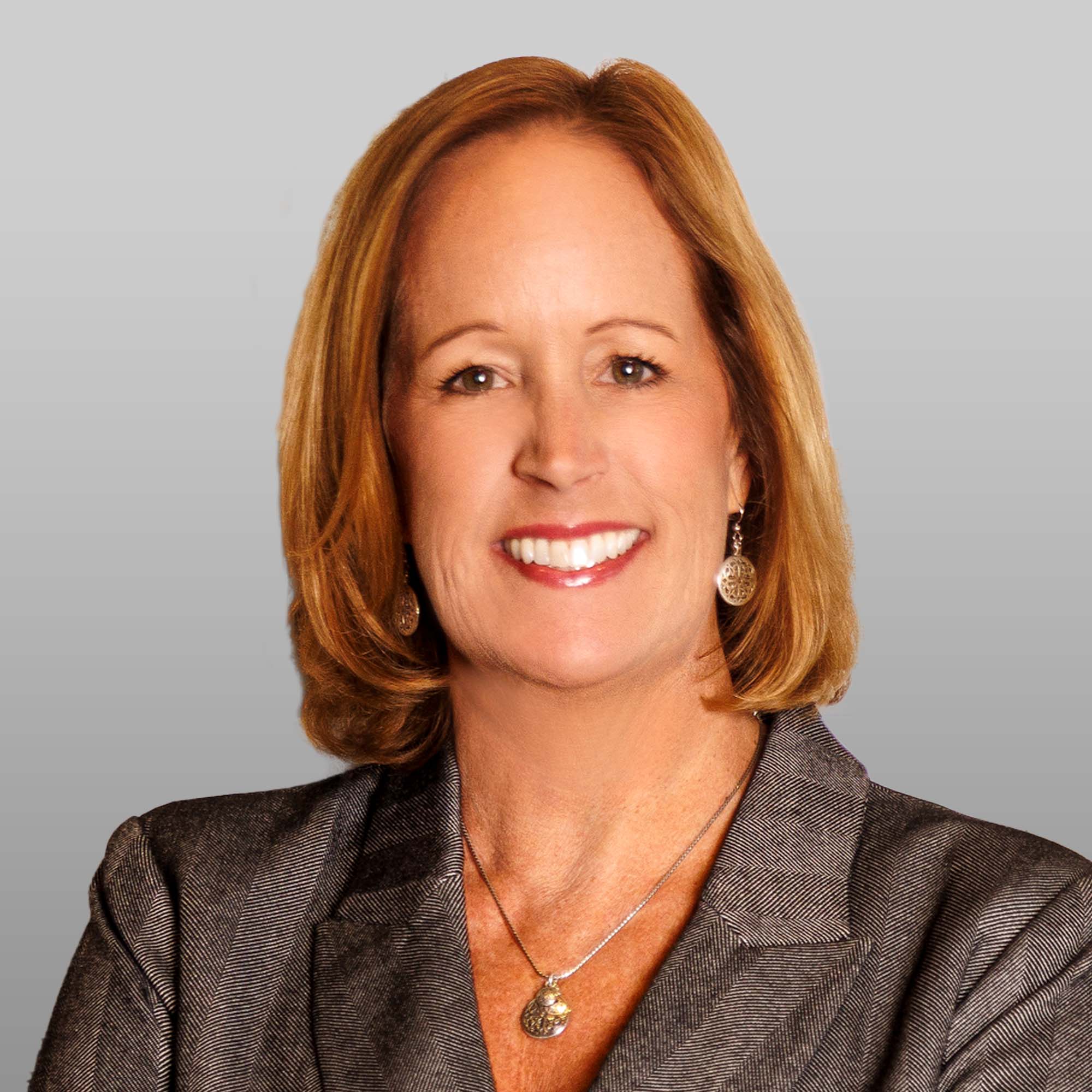 a woman with blonde hair wearing a suit
