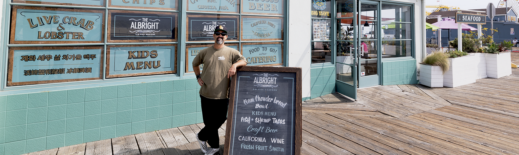 a man leaning against a sign