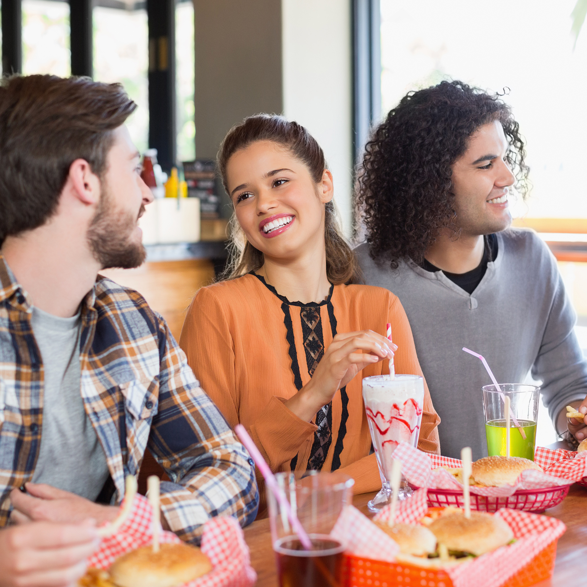 Three students enjoy a meal together
