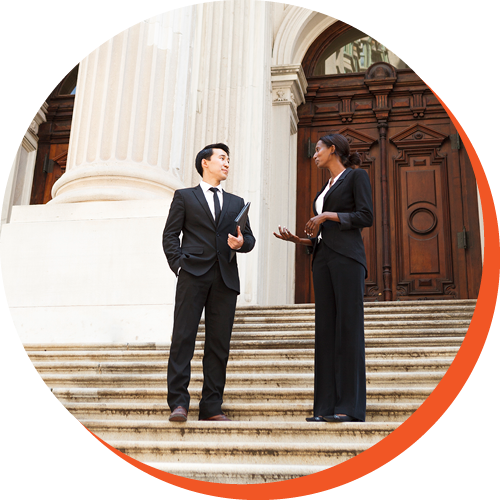 Two professionals talking outside on steps